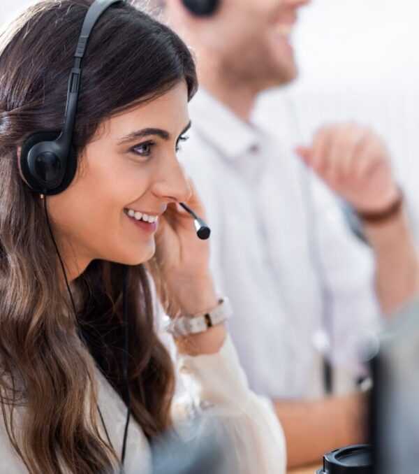 stock-photo-selective-focus-of-smiling-female-call-center-operator-in-office-1209093172-transformed