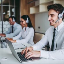 stock-photo-how-can-i-help-you-beautiful-call-center-workers-in-headphones-are-working-at-modern-office-726014614-transformed