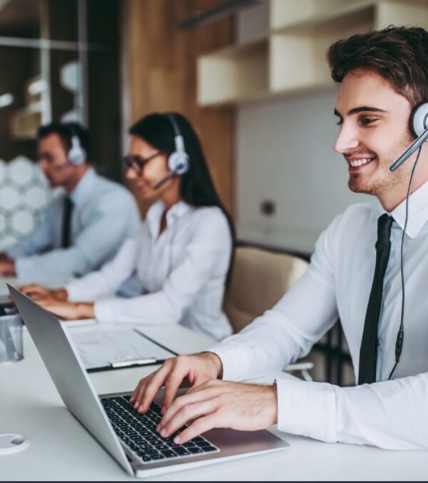stock-photo-how-can-i-help-you-beautiful-call-center-workers-in-headphones-are-working-at-modern-office-726014614-transformed