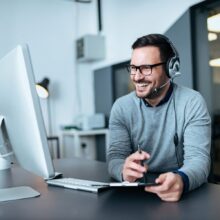 stock-photo-portrait-of-a-casual-smiling-businessman-using-headset-when-talking-to-customer-1235323882-transformed