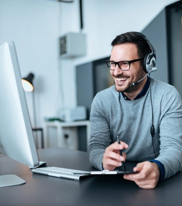 stock-photo-portrait-of-a-casual-smiling-businessman-using-headset-when-talking-to-customer-1235323882-transformed